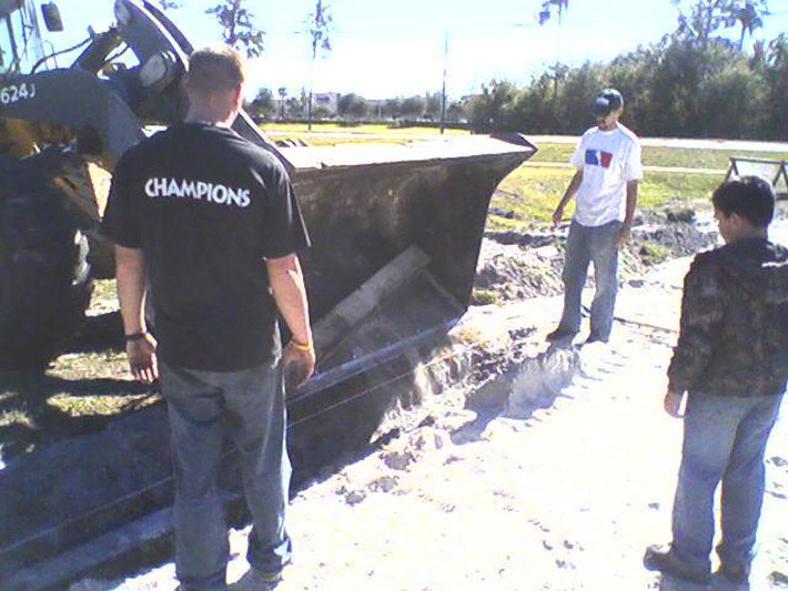 front end loader dumping a railroad tie